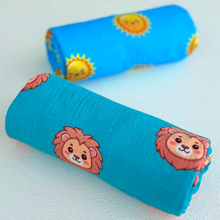Rolled organic muslin lion swaddle blanket. 
