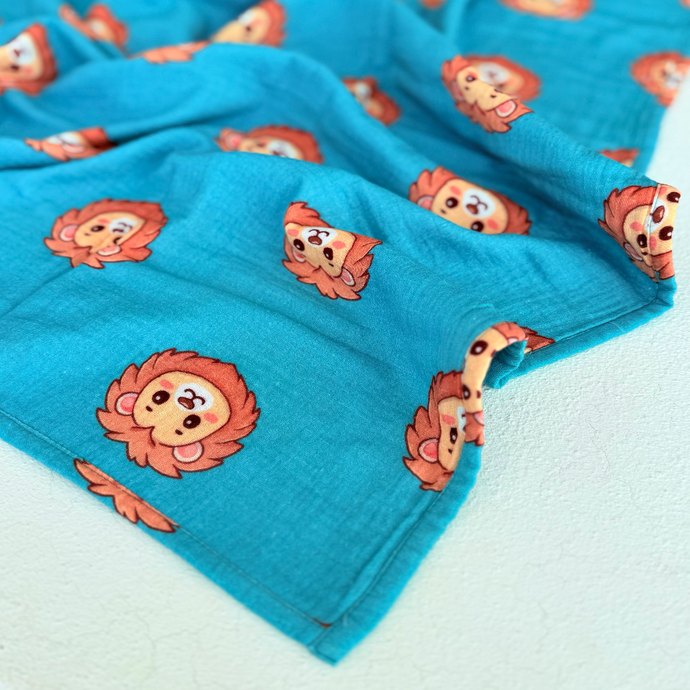 High contrast lion face print on muslin swaddle.  